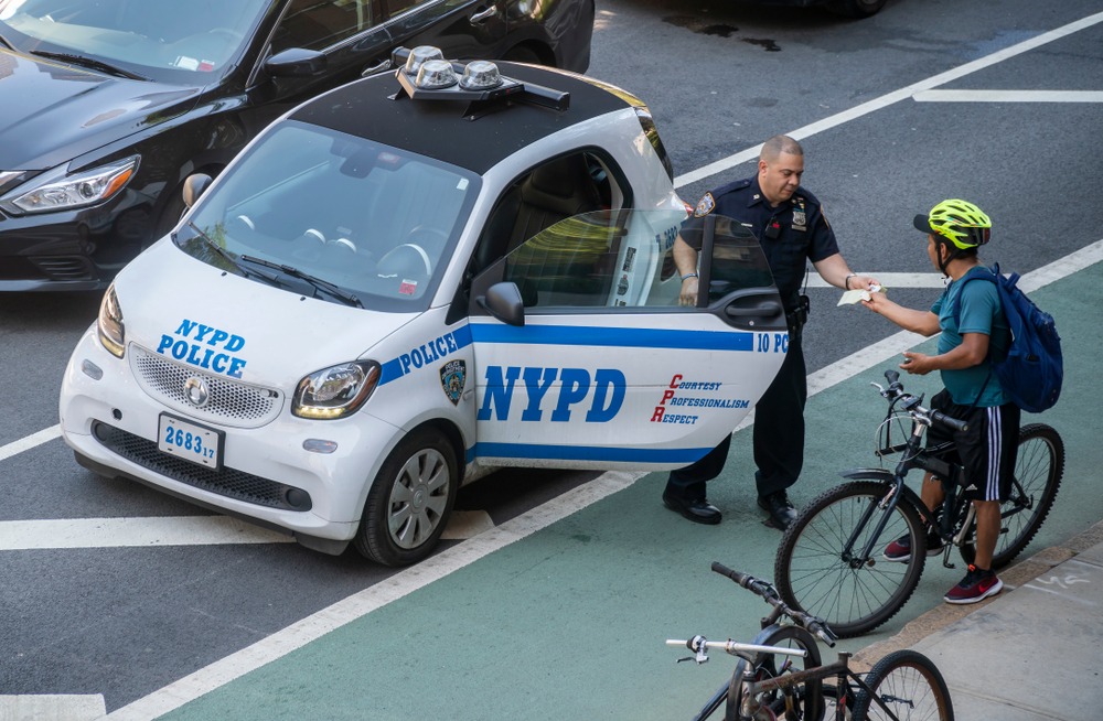 NYPD officer issues ticket to cyclist on city street