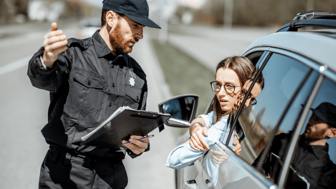 DC police officer issuing a speeding ticket to a driver in city traffic