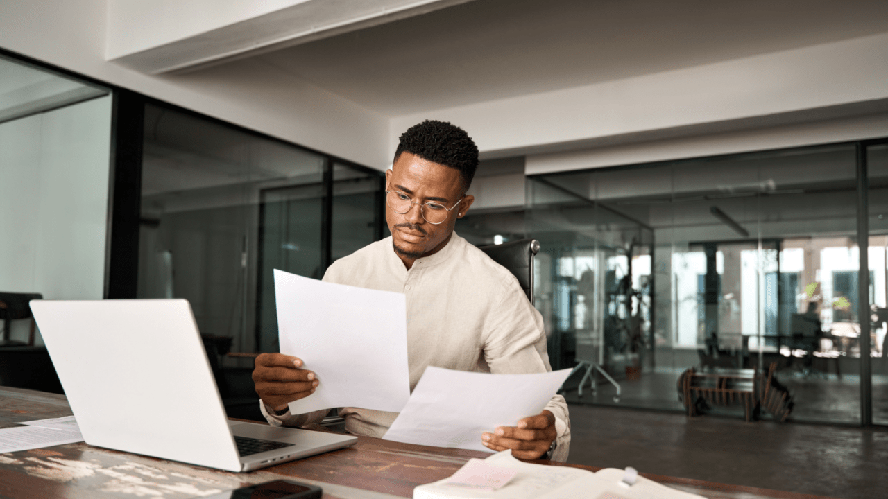 A professional man reviewing legal documents at an office desk