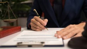 Lawyer writing on legal document – how do I write a guilty plea letter for speeding
