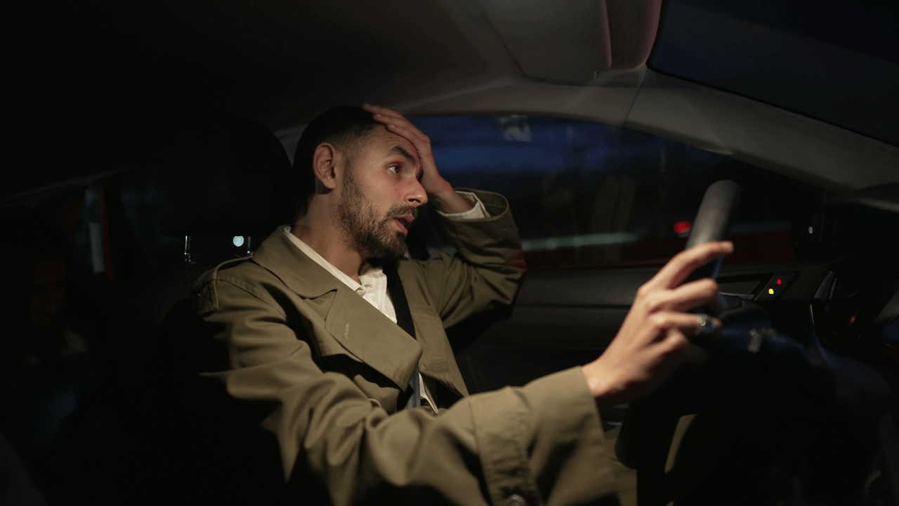 Should you plead guilty to reckless driving - stressed driver contemplating plea decision at night