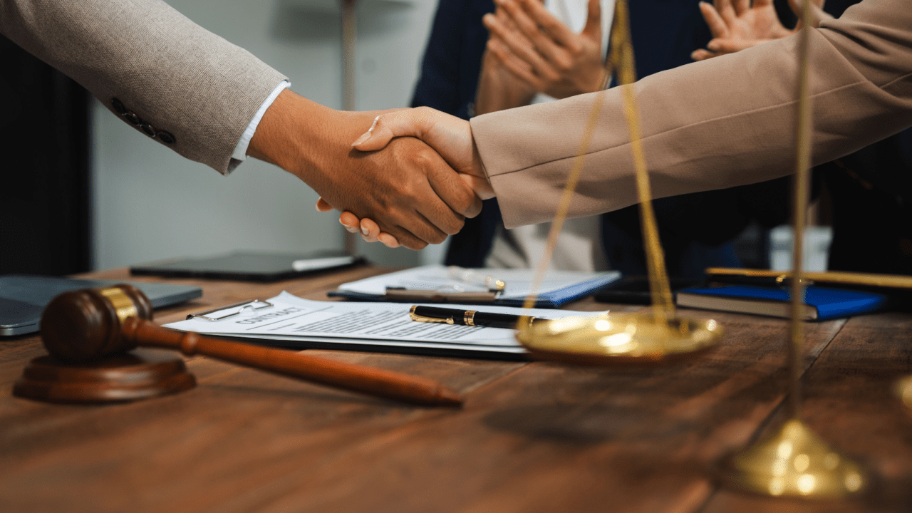 Professional handshake between client and attorney discussing do I need a lawyer for reckless driving in NJ consultation