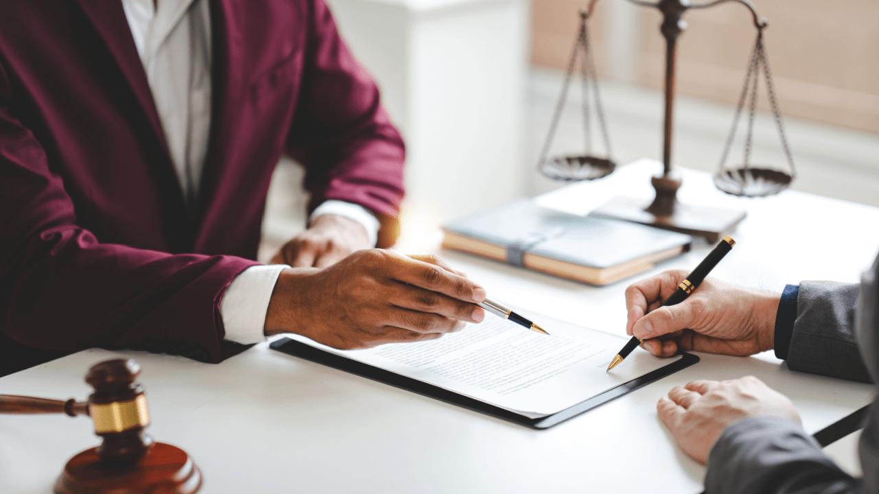Lawyer consulting with client about court-appointed attorney for reckless driving case
