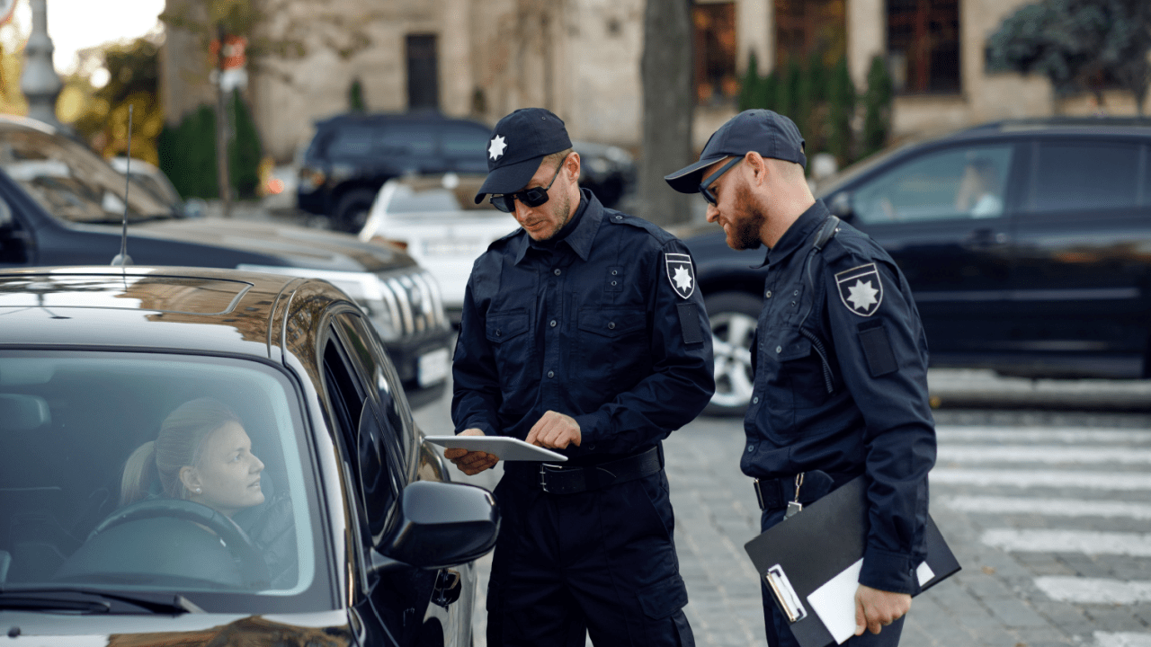 Police officers issuing traffic citation that may make driver wonder will reckless driving affect my insurance rates
