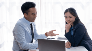 Professional lawyer explaining defense strategies for reckless driving ticket to female client during legal consultation