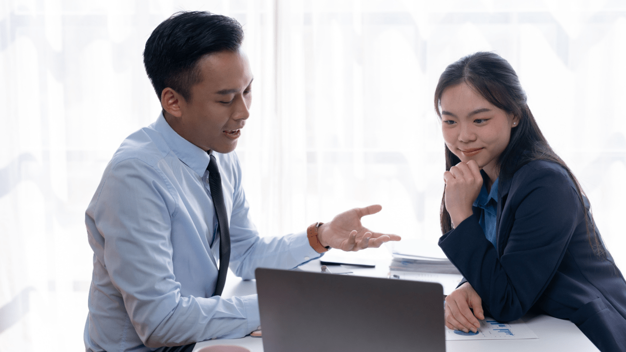 Professional lawyer explaining defense strategies for reckless driving ticket to female client during legal consultation