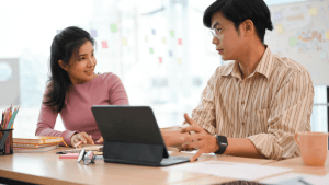 Young couple meeting with lawyer for red light ticket defense consultation at modern office desk