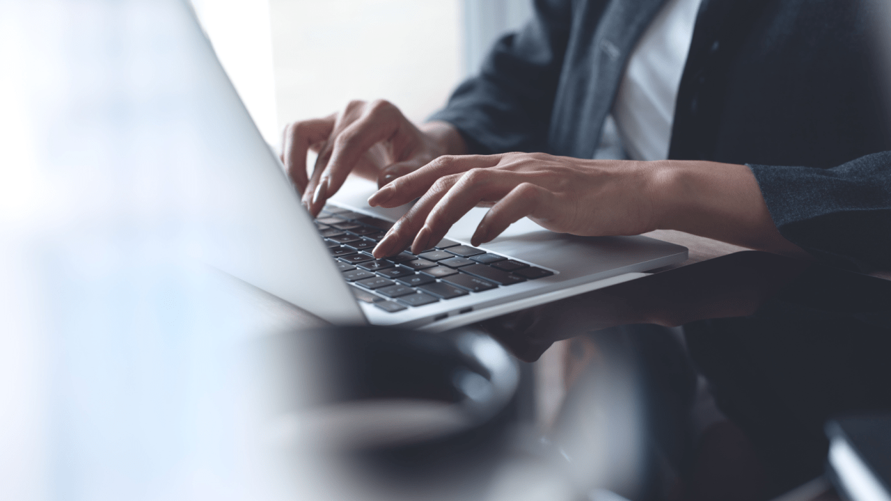 Professional hands typing on laptop researching legal strategies, representing how can a lawyer get a traffic ticket dismissed through expert case preparation and legal work