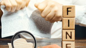 Traffic fine wooden blocks with magnifying glass showing how can a traffic lawyer get points off your license