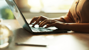 Person typing on laptop researching legal options in warm sunlight, investigating can a traffic lawyer get a dui reduced and exploring DUI defense strategies