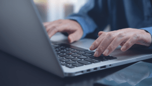 Person typing on laptop researching legal payment options, investigating do traffic lawyers offer payment plans and affordable legal service arrangements