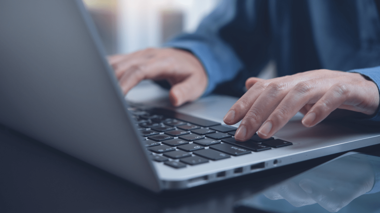 Person typing on laptop researching legal payment options, investigating do traffic lawyers offer payment plans and affordable legal service arrangements