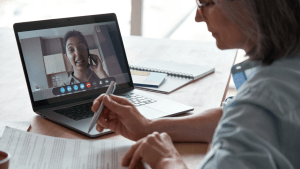 Person consulting with online traffic lawyer via video call to determine local vs online traffic lawyers which is better option