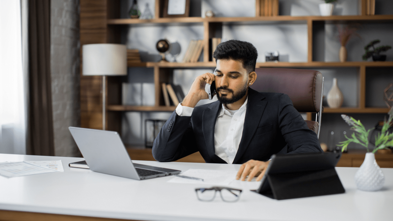 Seat belt violation lawyer speaking with client on phone in professional office