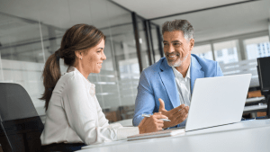 Professional lawyer consulting with satisfied client in modern office setting, illustrating when is hiring a traffic lawyer worth it for successful case outcomes