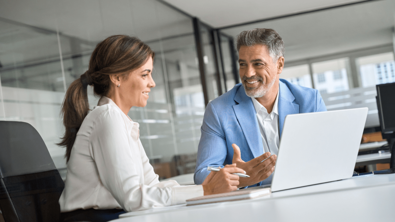 Professional lawyer consulting with satisfied client in modern office setting, illustrating when is hiring a traffic lawyer worth it for successful case outcomes