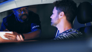 Police officer explaining how many traffic laws are there during traffic stop with driver