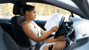 Woman reading traffic citation in car wondering how many traffic laws are there in Texas