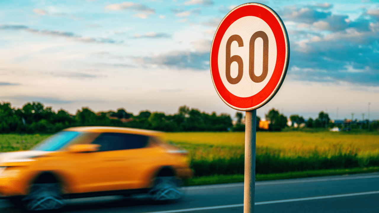 Speed limit sign showing 60 with car speeding past illustrating is speeding the most common crime in America
