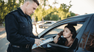 Police officer writing citation for what is the most common traffic violation while driver waits in vehicle
