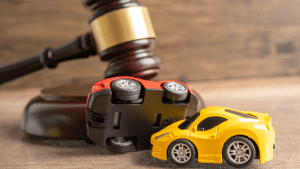 Judge gavel with car accident scene showing what outcomes can I expect from a traffic lawyer representation