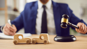 Judge with gavel and toy cars illustrating the basics and purpose of traffic laws in legal proceedings
