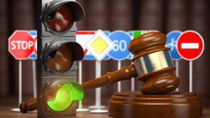 Traffic light and judge gavel illustrating what is the reason for traffic laws