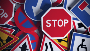 Various California traffic signs showing regulations written by state legislature who writes traffic laws in California