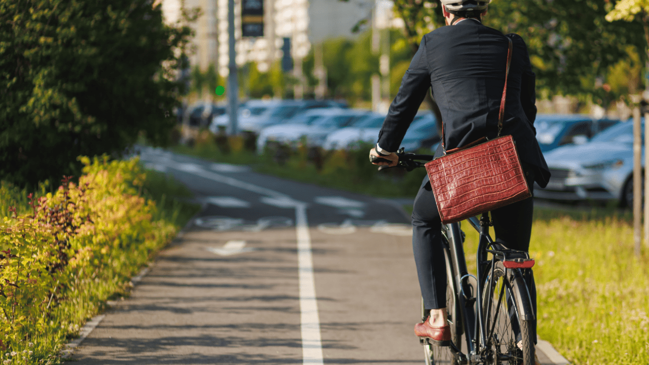 Professional cyclist commuting on dedicated bike path demonstrating how traffic laws are applied to bicycles in urban area