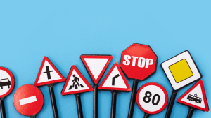 Various traffic signs including stop, yield, and speed limit demonstrating are traffic laws static and evolving road regulations