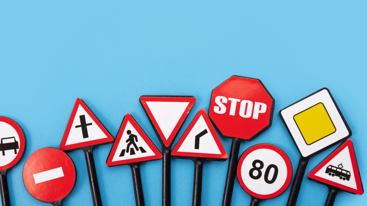 Various traffic signs including stop, yield, and speed limit demonstrating are traffic laws static and evolving road regulations