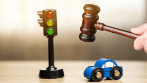 Traffic laws can change periodically concept with gavel, traffic light, and toy car representing legal updates