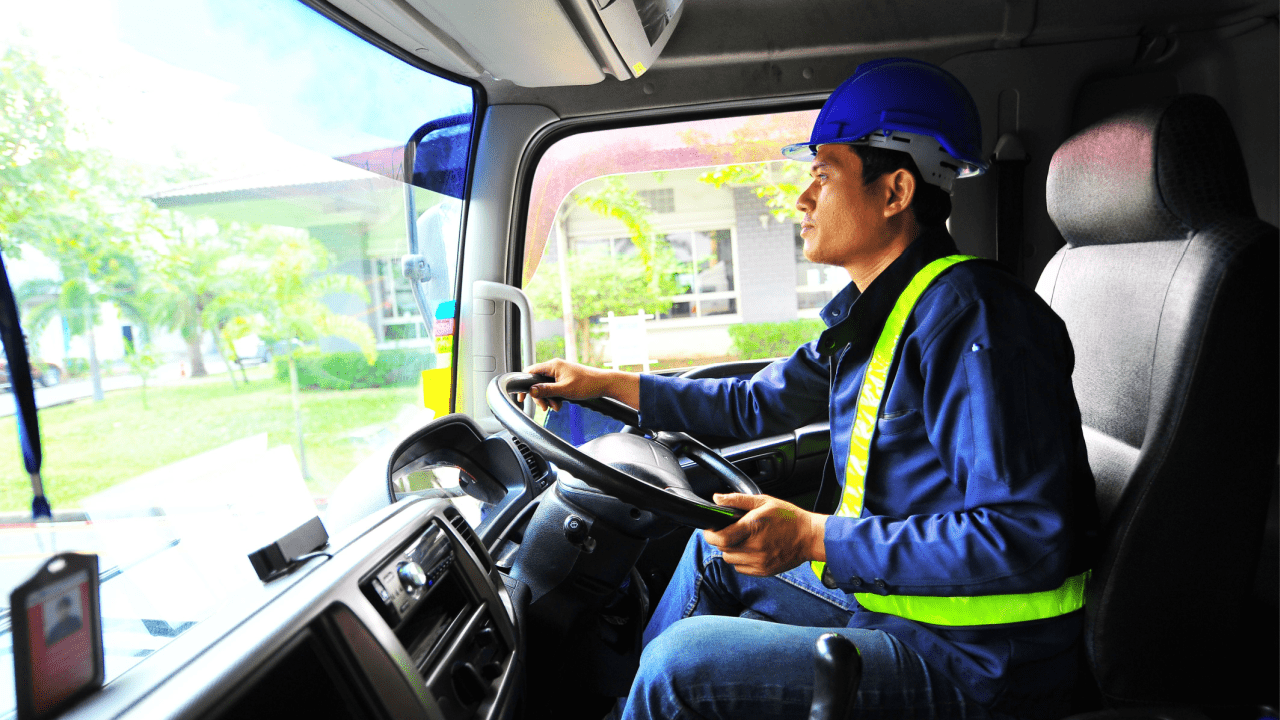 Commercial truck driver in safety vest understanding how bad DOT violations impact CDL career