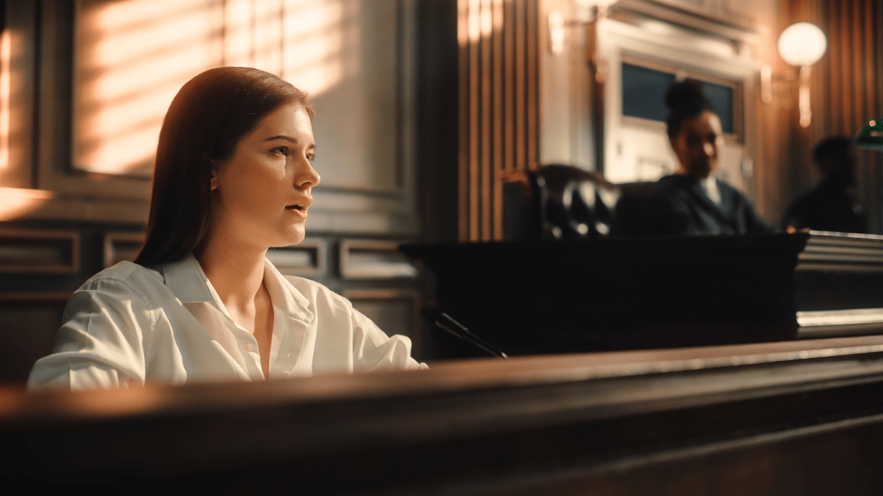 Woman defending herself in court without attorney representation facing prosecutor