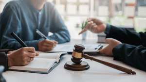 Attorney consultation showing how to argue a traffic ticket in court with legal documents and gavel on conference table