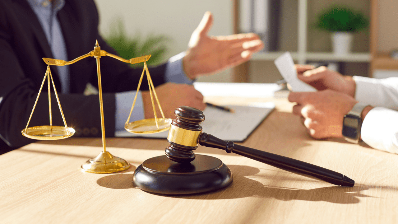 Is fighting a ticket worth it - Traffic attorney consultation with gavel and scales of justice discussing ticket defense options