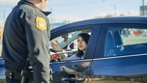 Woman explaining what to say when fighting a traffic ticket during roadside stop with police officer