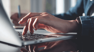 Professional driver researching CDL ticket duration on laptop computer