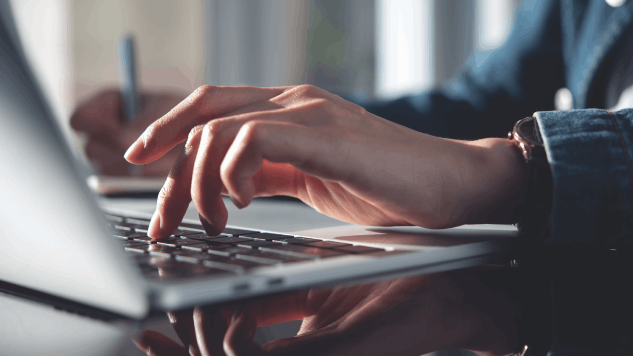 Professional driver researching CDL ticket duration on laptop computer