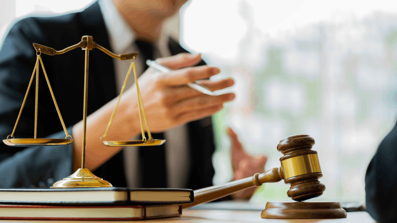 CDL legal risks without proper licensing consultation showing attorney discussing commercial driver compliance with gavel and scales of justice