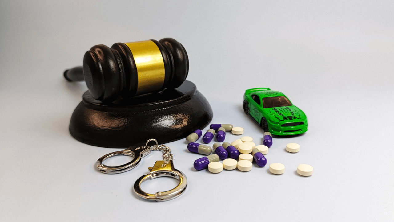 First offense DUI under state law consequences showing gavel handcuffs pills and toy car representing jail time exposure