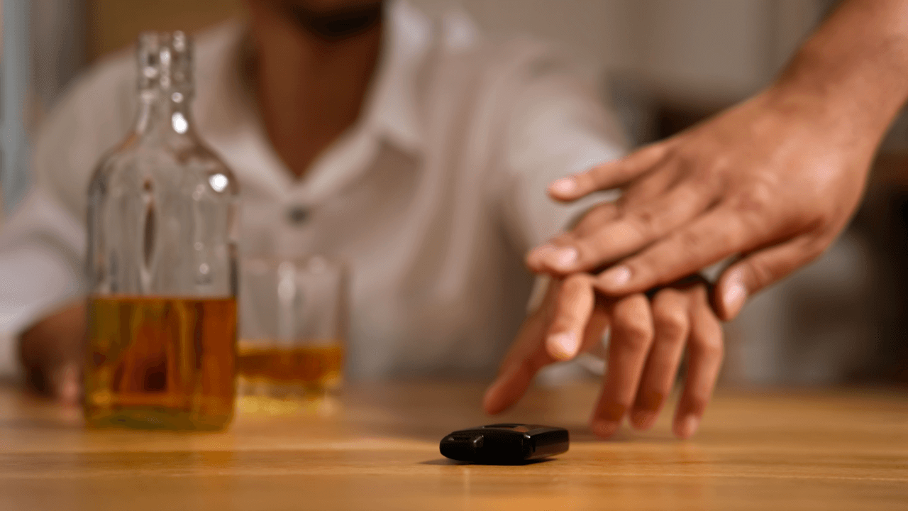 Person refusing alcohol with car keys on table illustrating states with zero alcohol tolerance laws for underage drivers