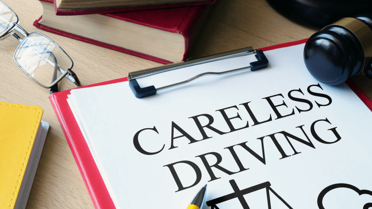 Careless driving legal document on clipboard with gavel and law books on desk