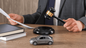 Is careless driving a major violation judge with gavel and toy car at legal desk