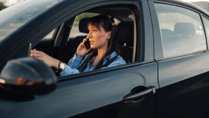Woman driving while talking on phone — careless driving misdemeanor risk