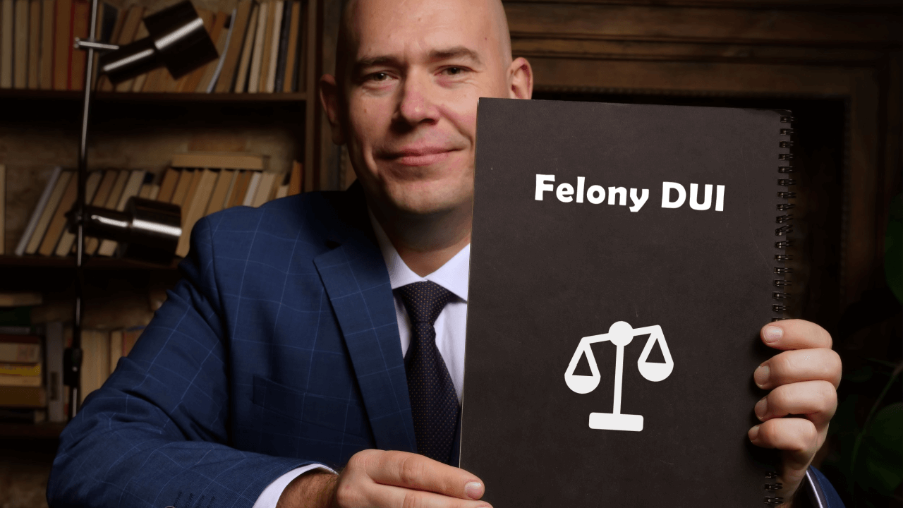 Attorney holding Felony DUI document with justice scales illustrating whether DUI is treated as a felony under some state laws