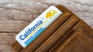 California driver license in wallet illustrating new California driving laws 2026 and traffic violation rules